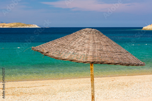 Straw umbrella in a sandy beaches of Kusadasi Region in Aegean Sea coastline of Turkey