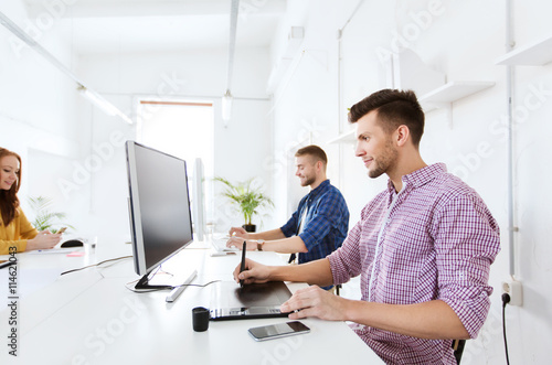 man or designer with computer and tablet at office