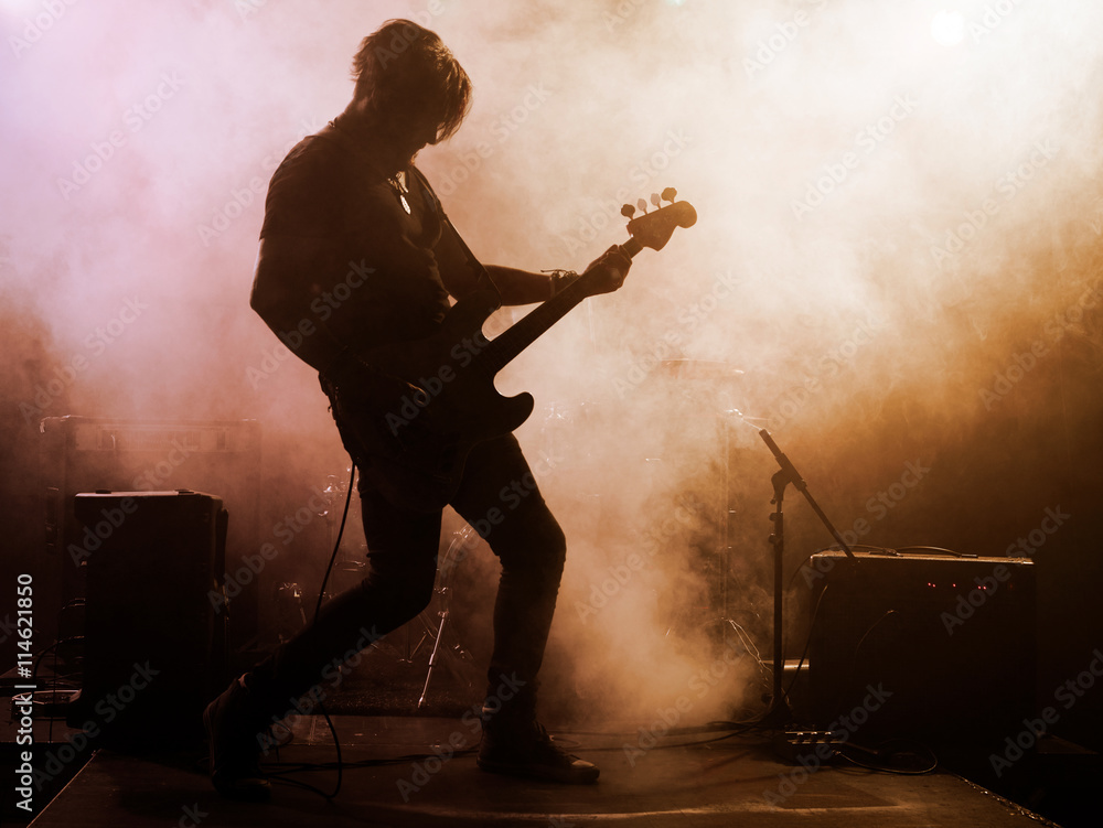 Naklejka premium Rock band performs on stage. Guitarist.