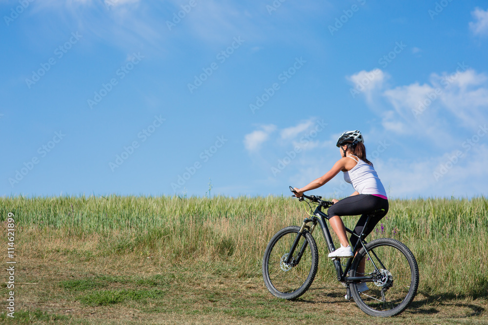 Sport bike woman on the meadow with a beautiful landscape Sport bike woman on the meadow with a beautiful landscape