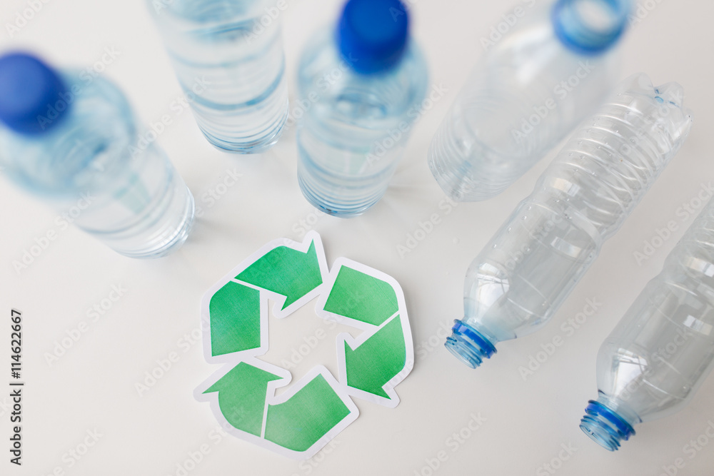 close up of plastic bottles and recycling symbol close up of plastic bottles and recycling symbol