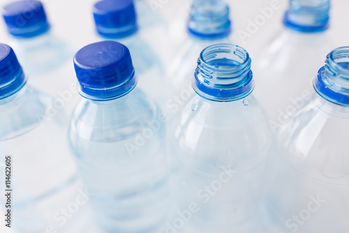 close up of bottles with drinking water on table