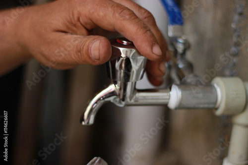 Plumber screwing plumbing fittings