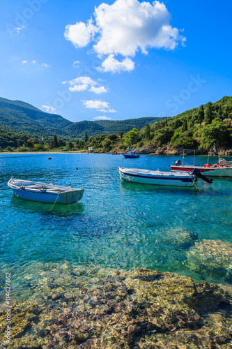 Fishing boats on turquoise sea in mountain landscape of Kefalonia island, Greece