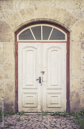 Old distressed white doors © ansyvan