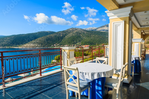 Table with chairs on terrace on coast of Kefalonia island in Agia Efimia village, Greece © pkazmierczak