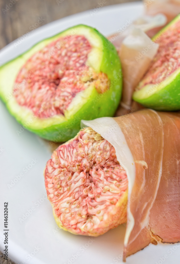 Figs and ham on white plate Figs and ham on white plate
