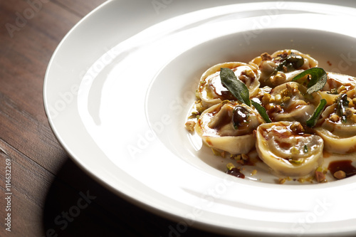 Handcrafted agnolotti on white dish