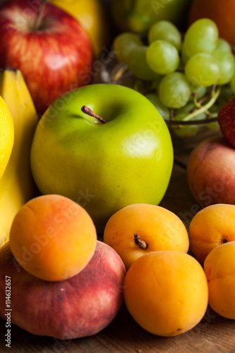 Assortment of fruits on wooden background