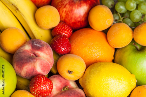 Assortment of fruits on wooden background