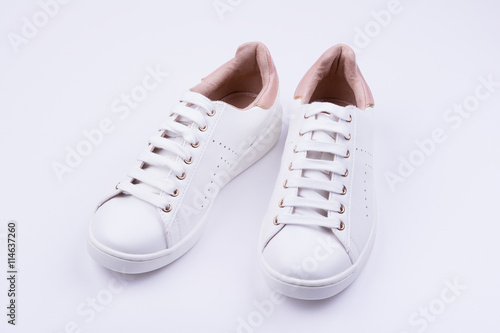 Women's white sport shoes on white background