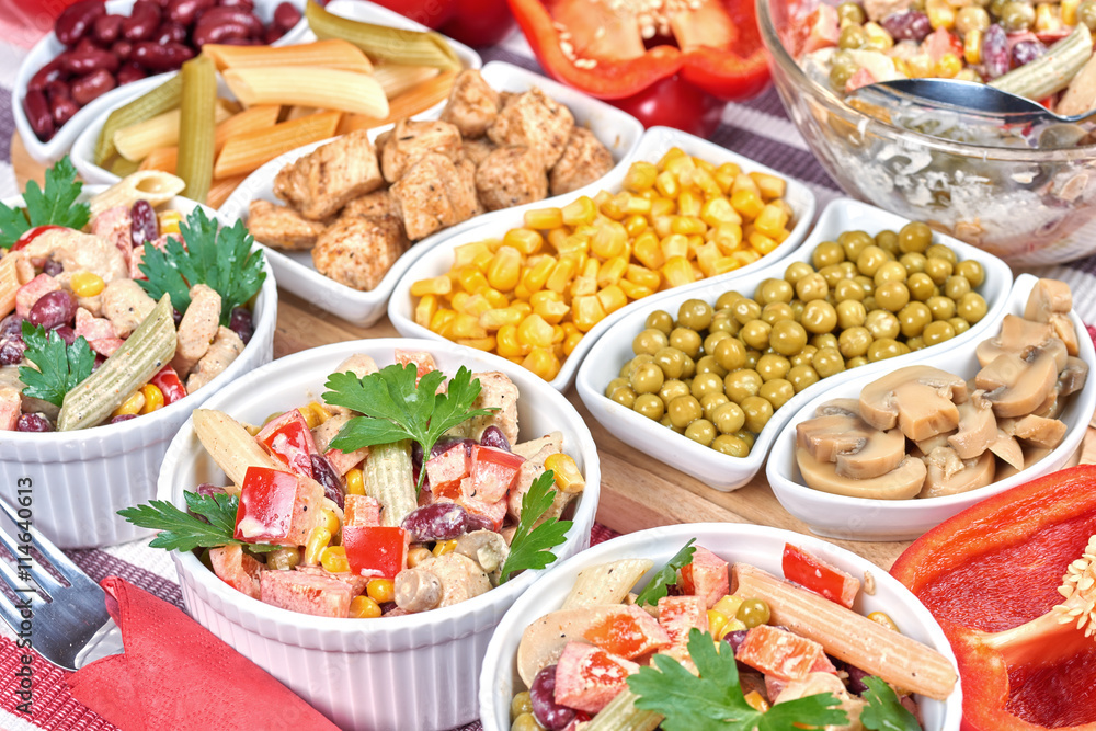 Chicken and vegetable salad in white bowls. Salad ingredients Chicken and vegetable salad in white bowls. Salad ingredients