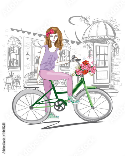 Fashion girl rides a bicycle the streets of the old town. Hand drawn illustration. 