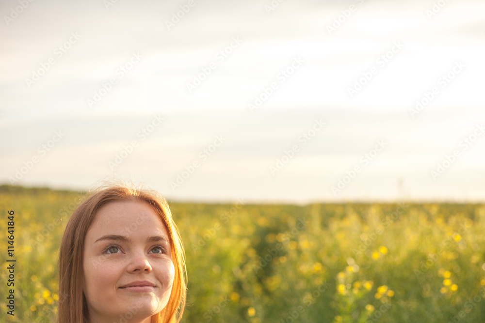woman with open arms in the green rapeseed field at the morning. woman with open arms in the green rapeseed field at the morning.