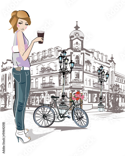 Fashion young girl drinking coffee in the street of old city.