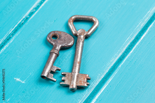 old key on a blue wooden background © merydolla