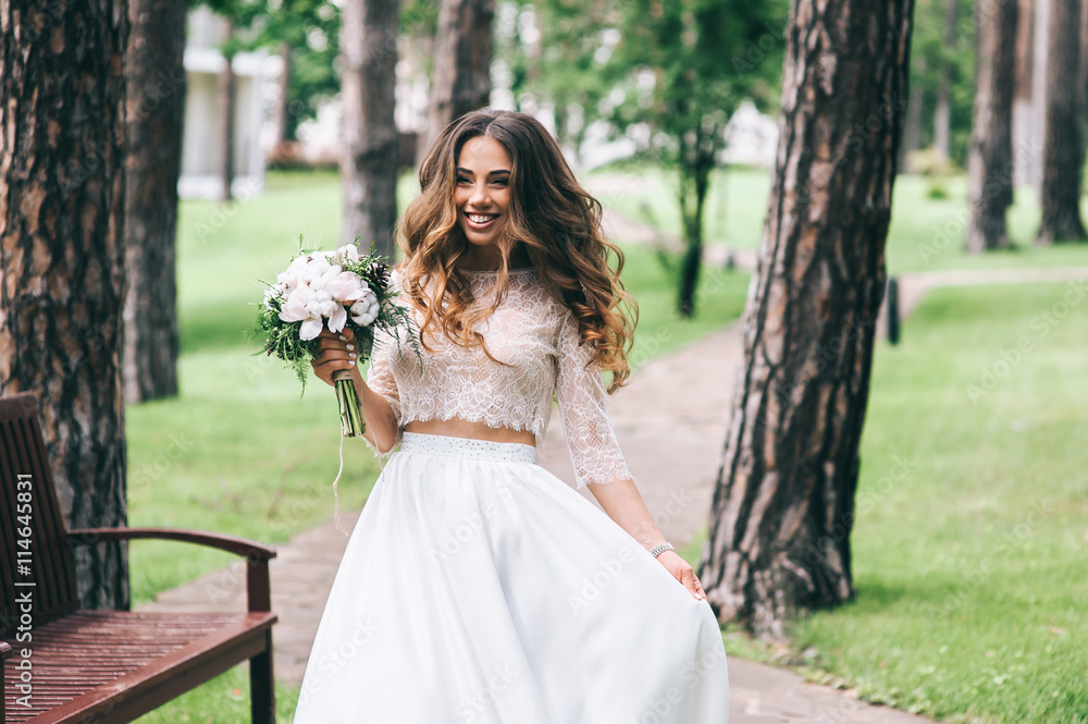 beautiful bride with white bouquet in park beautiful bride with white bouquet in park