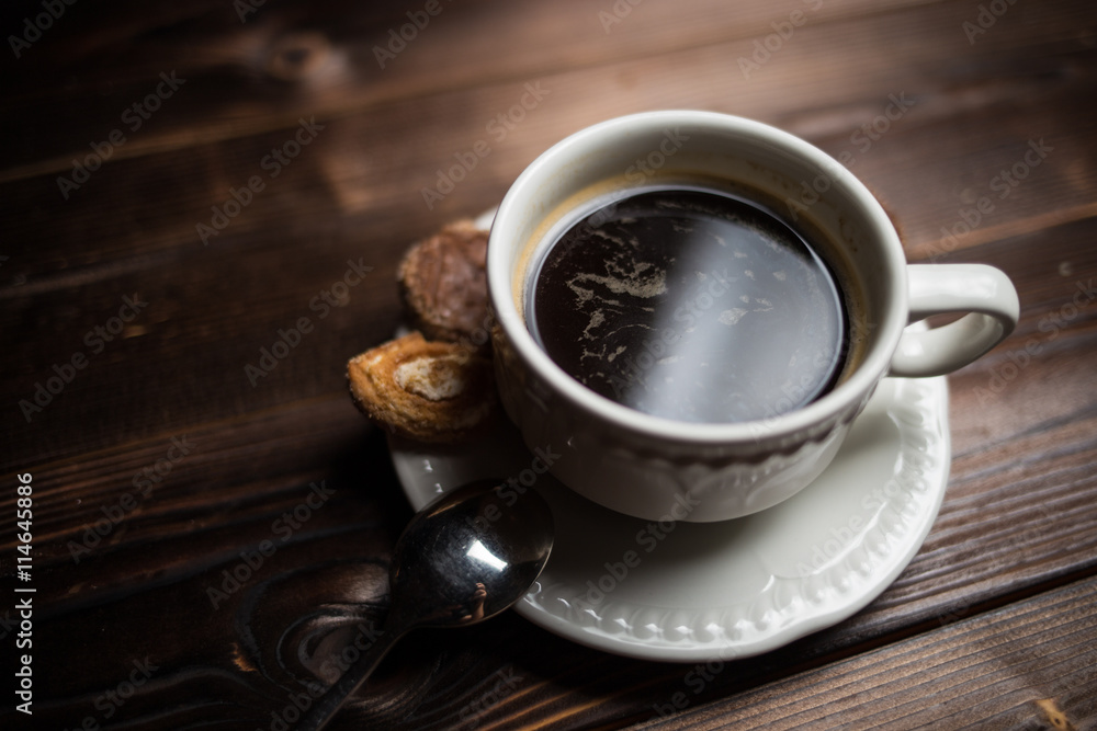 Fototapeta premium coffee americano with beans on wooden table