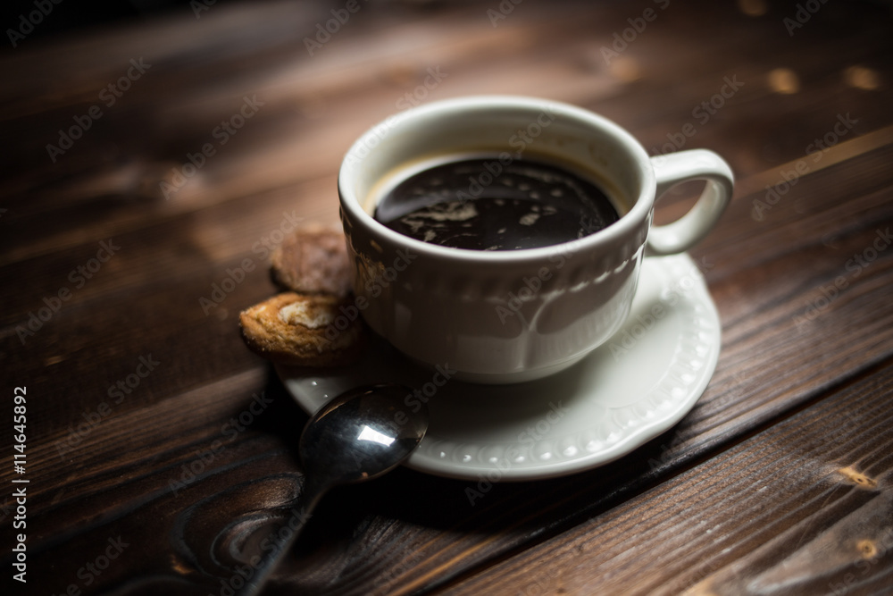 Fototapeta premium coffee americano with beans on wooden table