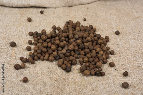 Aromatic allspice pepper seed on sack cloth