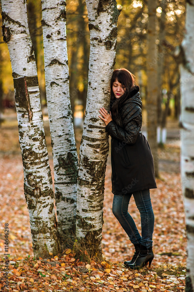 Beautiful Girl in Golden Autumn Leaves Park Hugging Tree. Relax. Beautiful Girl in Golden Autumn Leaves Park Hugging Tree. Relax.