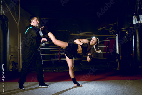 Girl kicking back leg during kickboxing practice © Alen Ajan