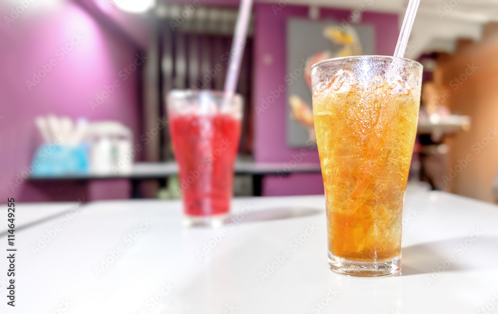 Lemon tea Thai herbal drinks with ice in glasses on the blurred cafe background. Lemon tea Thai herbal drinks with ice in glasses on the blurred cafe background.
