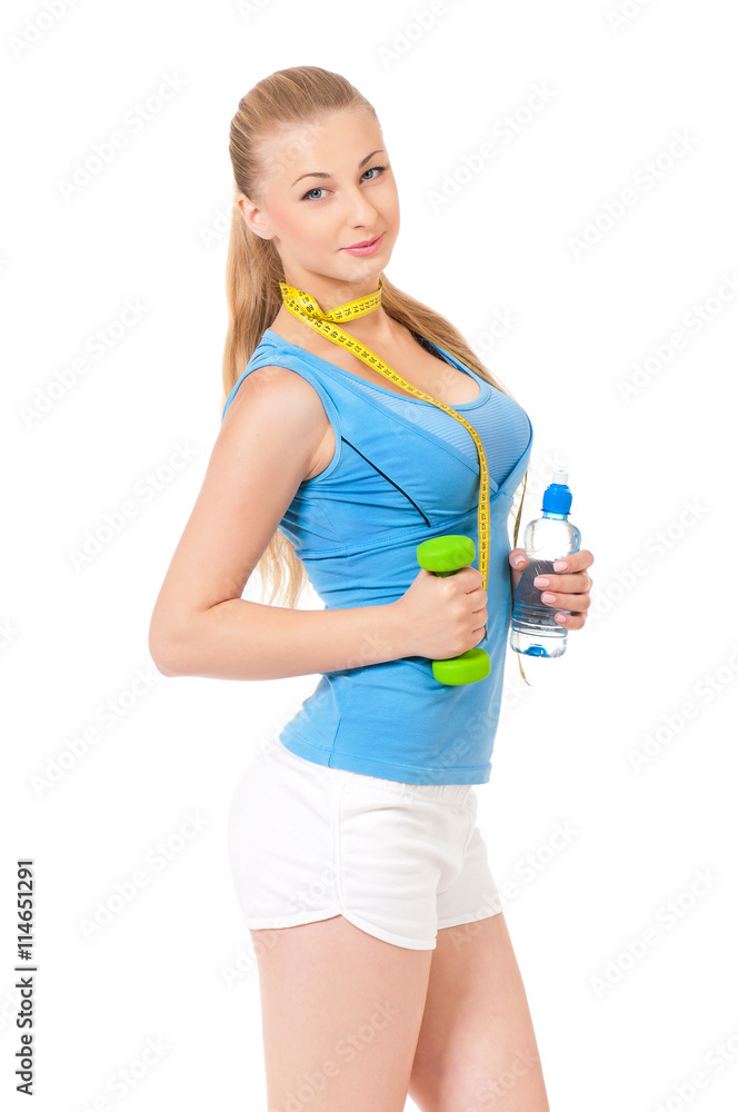 Woman exercising with dumbbell, bottle of water and measuring tape, portrait isolated over white background Woman exercising with dumbbell, bottle of water and measuring tape, portrait isolated over white background