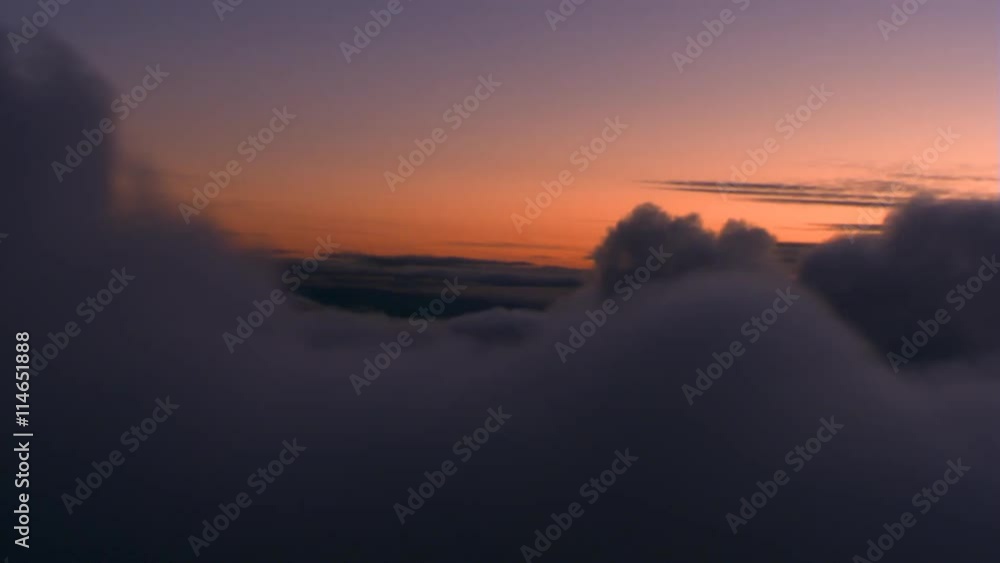 Flying past darkening sunset clouds, passenger POV Flying past darkening sunset clouds, passenger POV