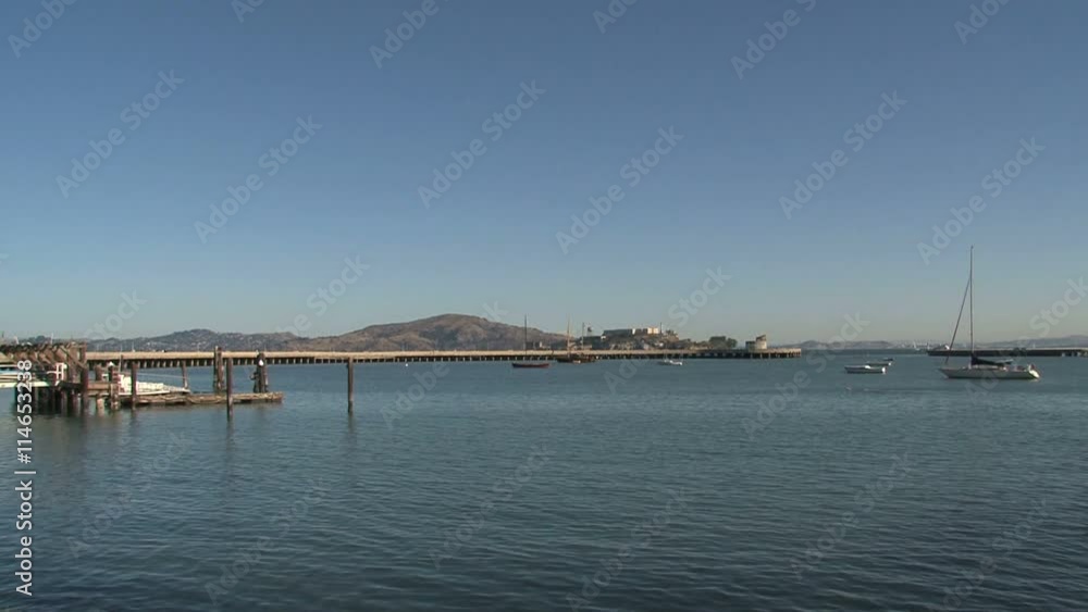 Swimmer in San Francisco bay with Alcatraz at the background in the morning Swimmer in San Francisco bay with Alcatraz at the background in the morning