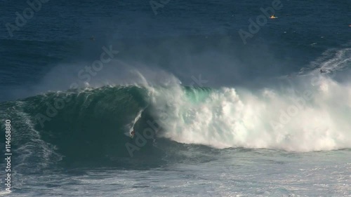 Surfer at the massive wave surfing break Jaws in at the north shore of the island of Maui, Hawaii photo