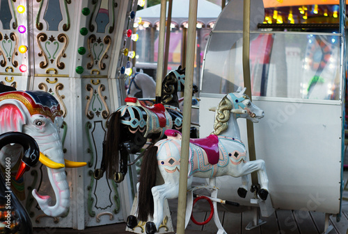 Carousel for children white Horse closeup in the amusement park