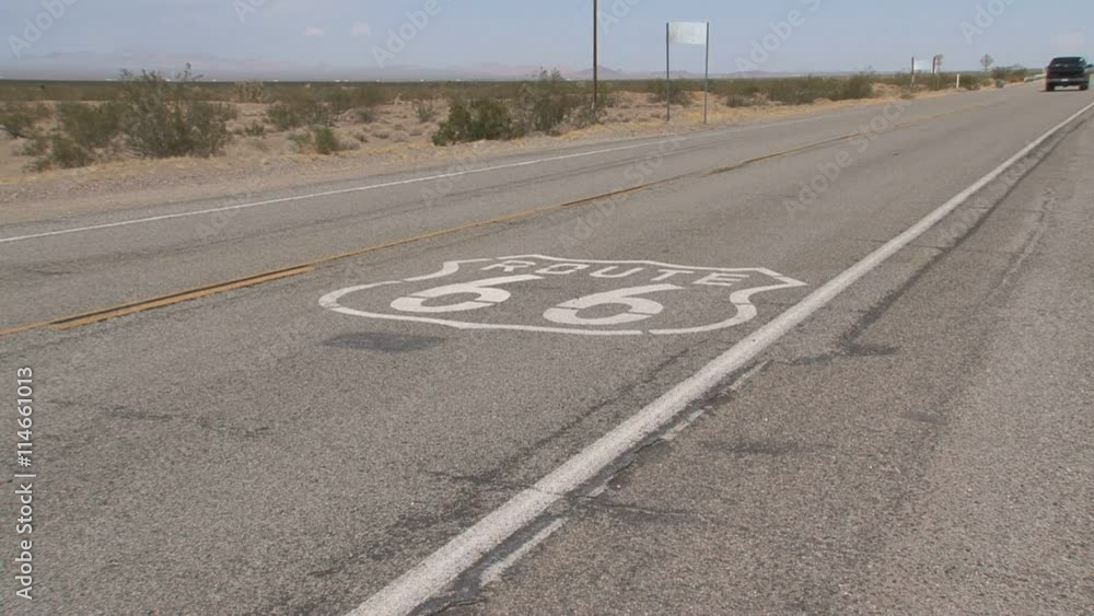 Car driving fast over the Route 66 sign Car driving fast over the Route 66 sign