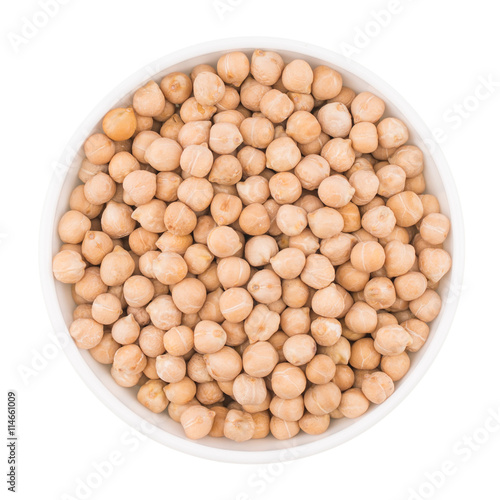 Chickpeas in a white bowl over white background