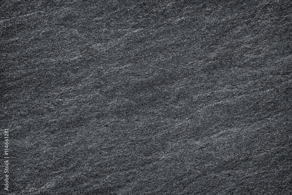Dark grey / black slate background or texture.