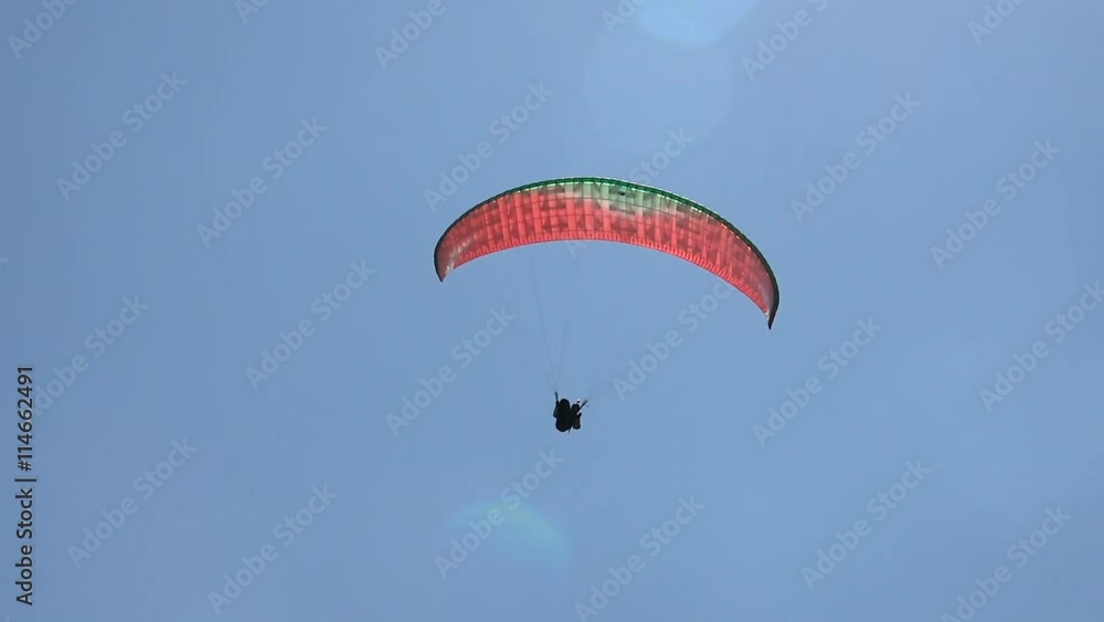 Flying Paraglider on a Background of Beautiful Clouds and Sun Glare. Summer, Sunny Day. Flying Paraglider on a Background of Beautiful Clouds and Sun Glare. Summer, Sunny Day.