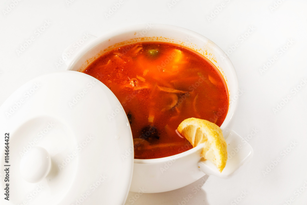 Solyanka mix soup with sausages, olives and lemon Solyanka mix soup with sausages, olives and lemon