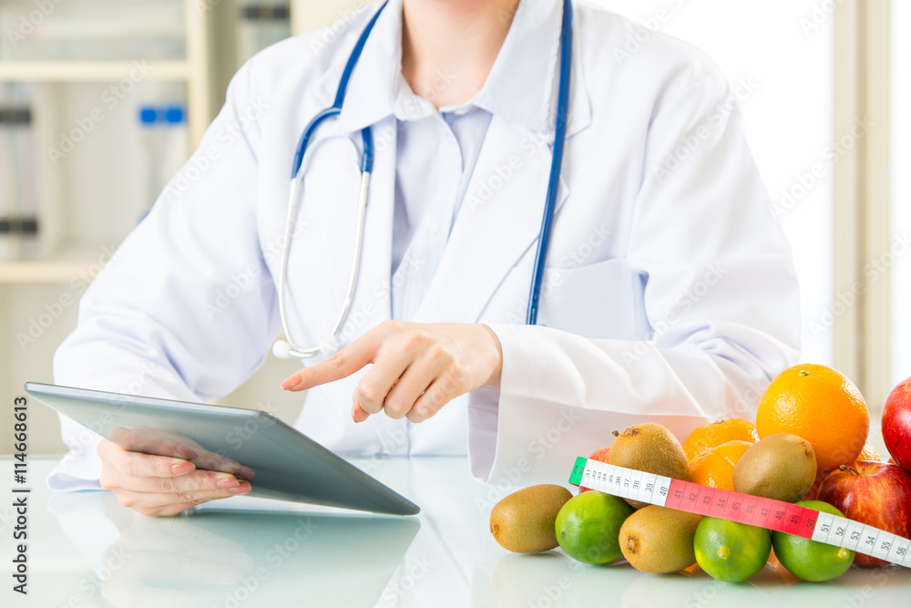Young asian nutritionist doctor using digital tablet Young asian nutritionist doctor using digital tablet