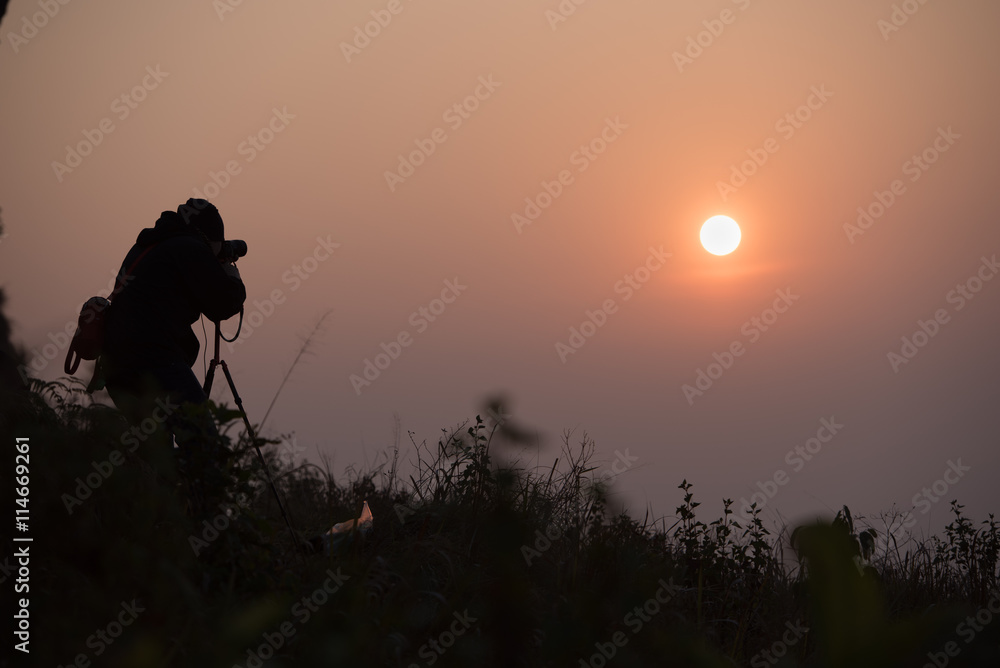 Photographer take a photo of the sunrise