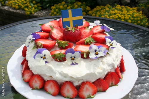 Swedish Midsummer gateau with strawberries and cream on top, vanilla cream and strawberries inside
