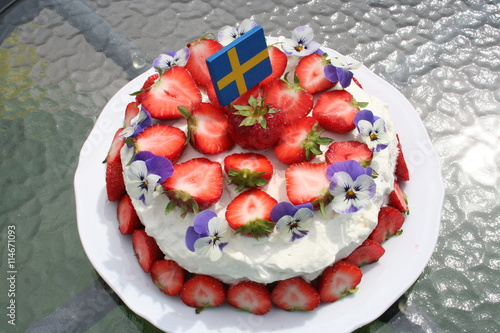 Swedish Midsummer gateau with strawberries and cream on top, vanilla cream and strawberries inside