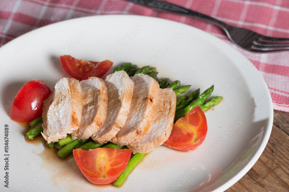 Chicken breast slice with asparagus and tomato.. Chicken breast slice with asparagus and tomato..