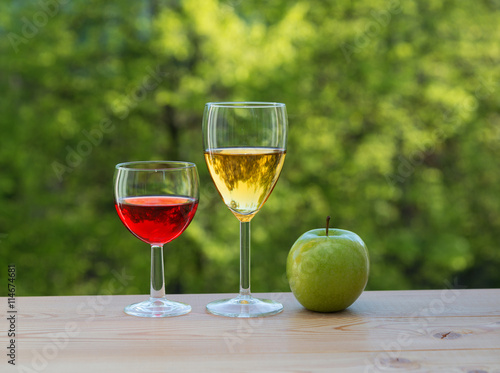 wine glasses and green apple on table