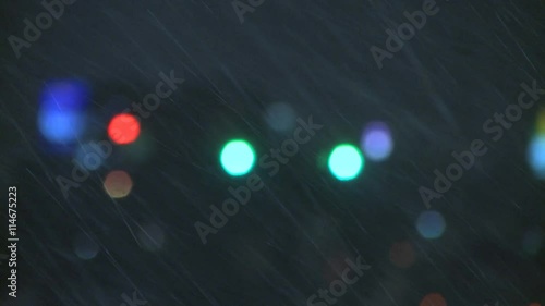 Multicolored disks of light seen through close-up sleety rain photo