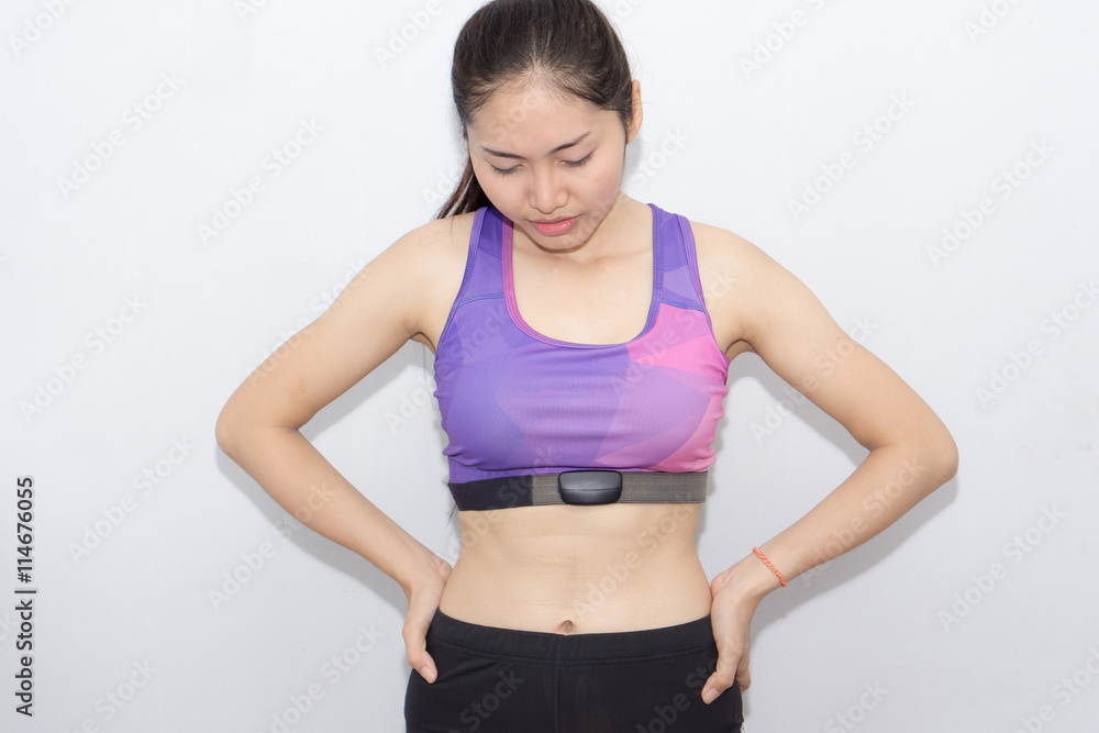 Woman in sport bra and heart rate monitor with tape isolated on Woman in sport bra and heart rate monitor with tape isolated on