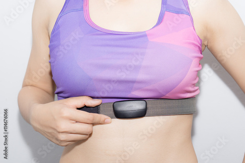 Woman in sport bra and heart rate monitor with tape isolated on