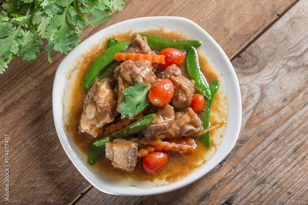 Pork ribs braised with soy sauce and vegetable. Top view. Pork ribs braised with soy sauce and vegetable. Top view.