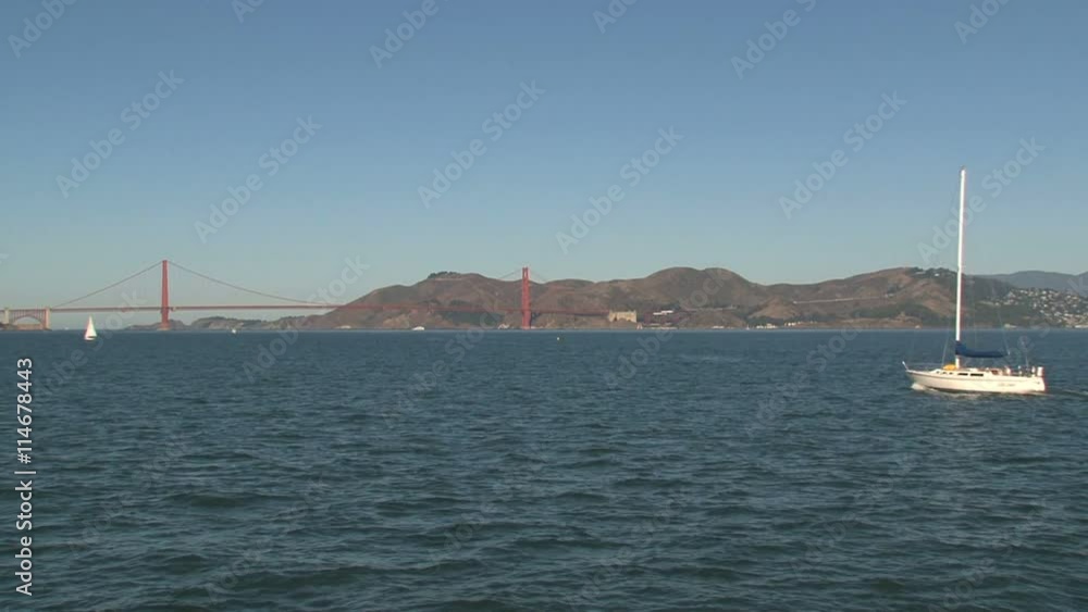 The Golden Gate Bridge in the morning with sailboat The Golden Gate Bridge in the morning with sailboat
