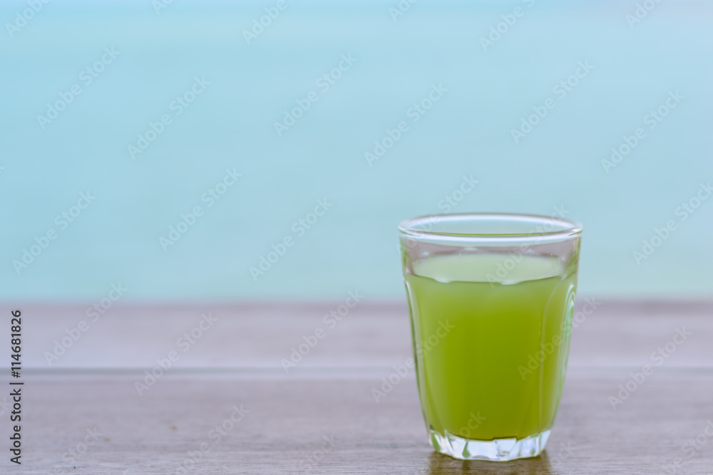 guava Juice on wood table with blur water sea background. guava Juice on wood table with blur water sea background.