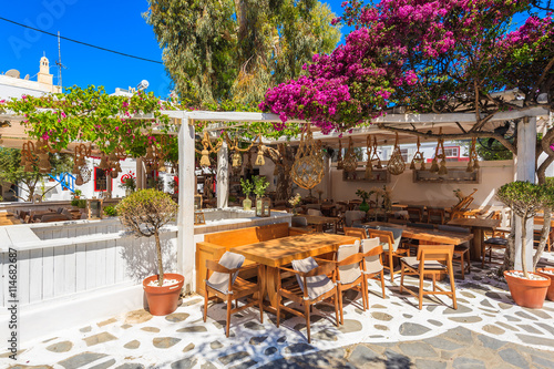 Typical Greek small restaurant on street in beautiful Mykonos town, Cyclades islands, Greece